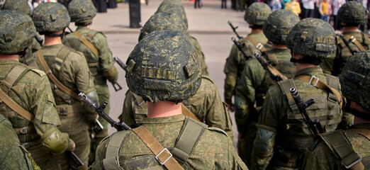 Russian soldiers in camouflage uniforms and helmets marching in a military parade