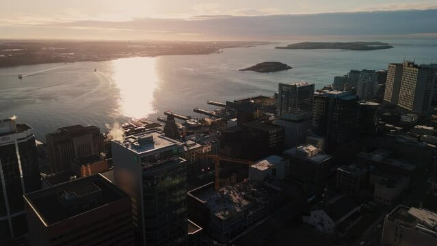 A cinematic drone shot of the city of Halifax, the Skyline, a mix of historic and modern buildings, stands proud against the sunrise. 