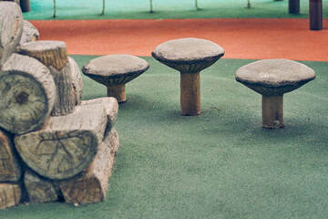 Wooden chairs that look like mushrooms. Modern eco-friendly equipment for an outdoor playground in the park. Design concept of a playground with space to copy. High quality photo