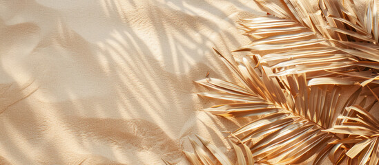 golden palm leaves arranged on a sandy texture creating a luxurious tropical feel