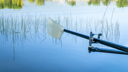 hatchet sculling oar on a calm lake, Boyd Lake in Colorado