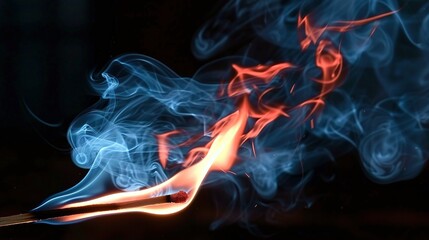 Fototapeta premium A close-up of a matchstick emitting blue and red smoke from its tip
