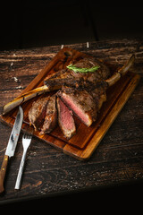 sliced rare grilled tomahawk steak