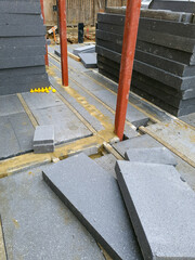 Obraz premium Ground floor installation with building materials, insulation boards, and construction tools. Preparation for residential development in an urban area.