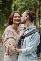 Love, hug and happy with couple in park for romance, bonding and summer vacation. Loving young couple hugging and smiling together on nature background. Beautiful girl with tattooed body outdoor.