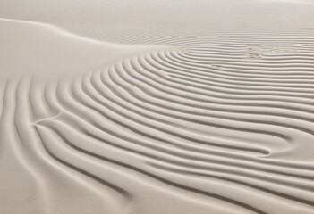 Buddhist-inspired traditional garden with rough white sand and curved wave patterns, creating a calm and serene space for meditation and relaxation in minimalist Japanese style
