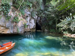 Belize Cave with lagoon and canoes