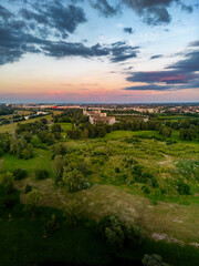 Fototapeta premium Aerial view of abandoned Blato hospital on the outskirts of Zagreb city, Croatia at sunset, overgrown in vegetation and bush