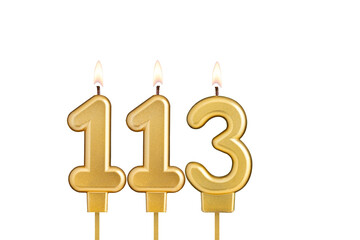 Golden number 113 birthday candle on white background
