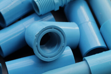 Plumber equipment with blue pvc pipe connections for plumbing work.