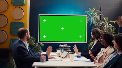 Promotions manager and team members watching a video on mockup screen, analyzing PR and digital marketing ad campaign. Firm employees reviewing sales strategy in a fruitful meeting. Camera B.