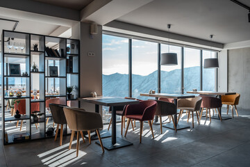 modern restaurant with panoramic windows and snowy mountains with nature view