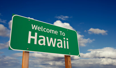 Welcome To Hawaii Green Road Sign Over Blue Sky with Some Clouds. © Andy Dean