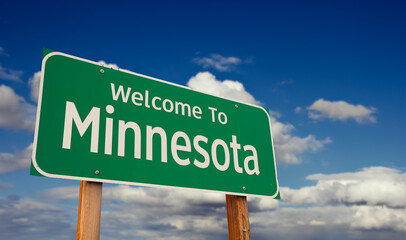 Welcome To Minnesota Green Road Sign Over Blue Sky with Some Clouds. © Andy Dean
