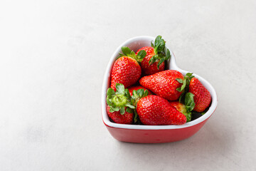 Fresh strawberries in heart bowl