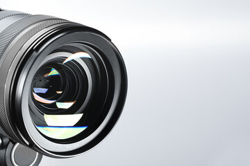 Modern camera lens on white background, closeup. Space for text