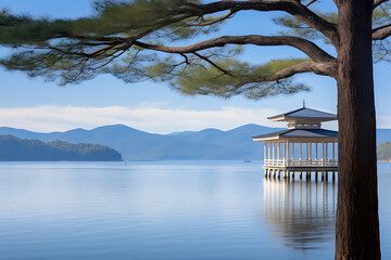 Tranquil blue lake with a white pavilion and green pine tree, showcasing serene nature and peaceful escape. 