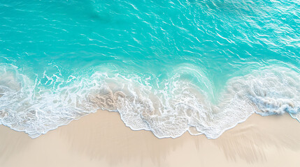 Obraz premium Turquoise water and white foam crashing on a sandy beach, perfect for summer vacation and travel. 