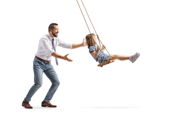 Full length profile shot of a man pushing a kid on a swing