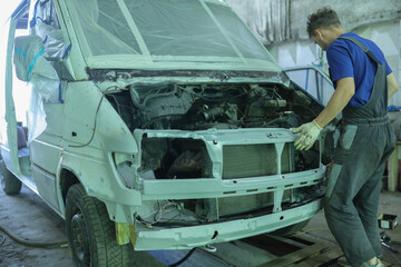 body repair of a car van in a workshop, painting.