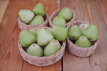 A water guava resting in a rattan basket