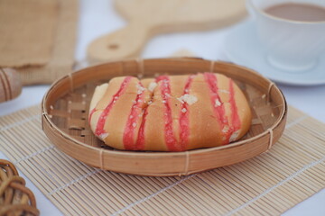 Strawberry bread and  milk chocolate on a bamboo mat