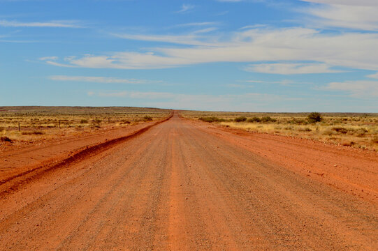 A graded red dirt road near the Breakaways north of Coober Pedy, South Australia. - Powered by Adobe