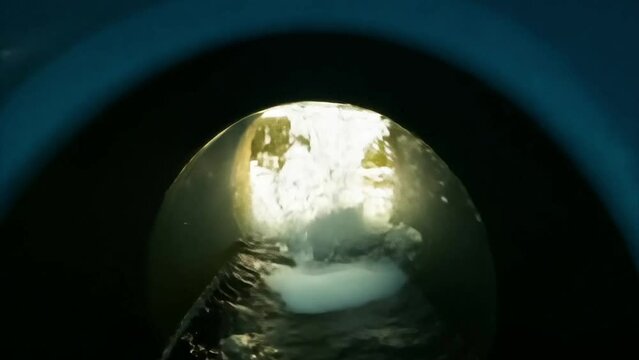 POV being flushed down the toilet and emerging into a drone shot of a beautiful estuary at sunset.