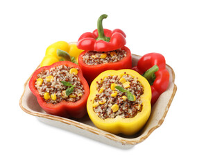 Quinoa stuffed bell peppers and basil in baking dish isolated on white