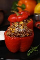Quinoa stuffed peppers with corn and basil on table, closeup