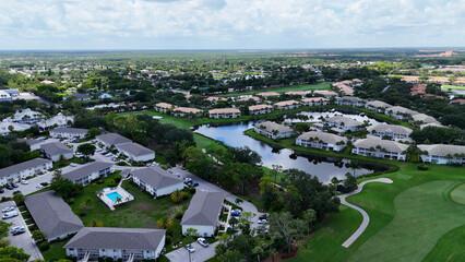 Golf course and community in Naples, Florida with luxury housing and condominiums along the course. Real estate investment background drone photo