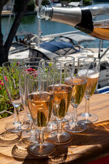 Summer party, French brut rose champagne sparkling wine in flute glasses in yacht harbour of Port Grimaud near Saint-Tropez, French Riviera vacation, Var, France