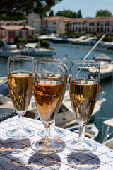 Summer party, French brut rose champagne sparkling wine in flute glasses in yacht harbour of Port Grimaud near Saint-Tropez, French Riviera vacation, Var, France