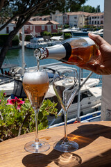 Summer party, French brut rose champagne sparkling wine in flute glasses in yacht harbour of Port Grimaud near Saint-Tropez, French Riviera vacation, Var, France