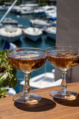 Summer party, French brut rose champagne sparkling wine in coupe glasses in yacht harbour of Port Grimaud near Saint-Tropez, French Riviera vacation, Var, France