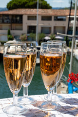 Summer party, French brut rose champagne sparkling wine in flute glasses in yacht harbour of Port Grimaud near Saint-Tropez, French Riviera vacation, Var, France