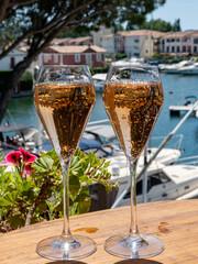 Summer party, French brut rose champagne sparkling wine in flute glasses in yacht harbour of Port Grimaud near Saint-Tropez, French Riviera vacation, Var, France
