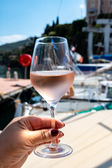 Party with rose wine on yacht boat anchored in port la Rague, Gulf of La Napoule, in Provence, two glasses of cold rose wine, French Riviera near Cannes, south of France