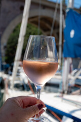 Party with rose wine on yacht boat anchored in port la Rague, Gulf of La Napoule, in Provence, two glasses of cold rose wine, French Riviera near Cannes, south of France