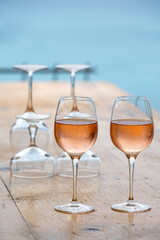 Summer time in Provence, two glasses of cold rose wine with blue sea view on background, French Riviera near Menton, south of France