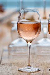 Summer time in Provence, two glasses of cold rose wine with blue sea view on background, French Riviera near Menton, south of France