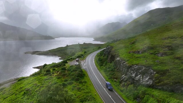 Aerial view of roads over mountains in the Scottish Highlands during rainy weather
