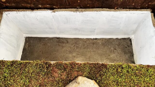 fresh empty grave ready for burial. Cemetery