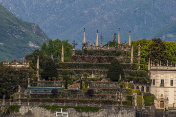 Isola Bella picture taken from the boat with visible boat rope.
Majestic island on lake Maggiore with Alps visible in background