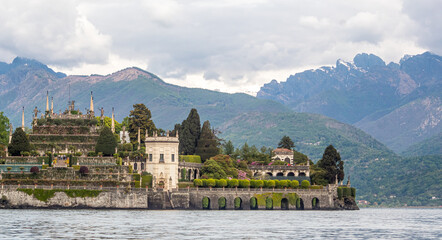 Isola Bella picture taken from the boat with visible boat rope.
Majestic island on lake Maggiore with Alps visible in background