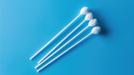 Sterile cotton swab for ear cleaning and household hygiene on blue background