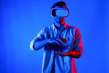 Caucasian smart man holding and moving gesture while using VR goggle. Happy person using headset...