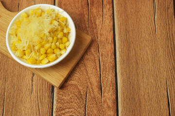 Closeup photo of some shaved corn sprinkled with sweet cheese