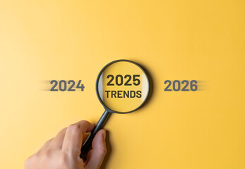 Marketing trends in 2025, with trends from the past year and into the future concept. Magnifying...