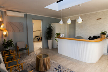 Reception area in medical clinic with modern decor and seating arrangement, copy space